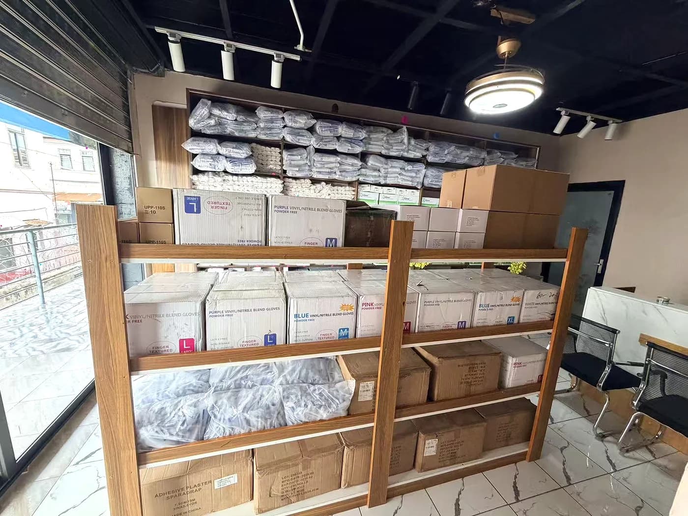 Wooden shelving holding boxed dressings, gauze and disposables