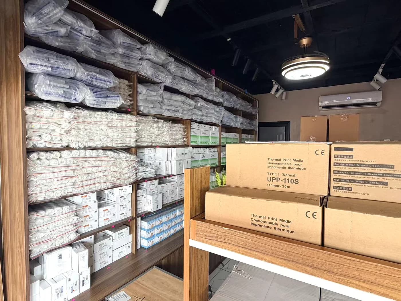 Cartons of thermal print media and boxed stock on the packing bench